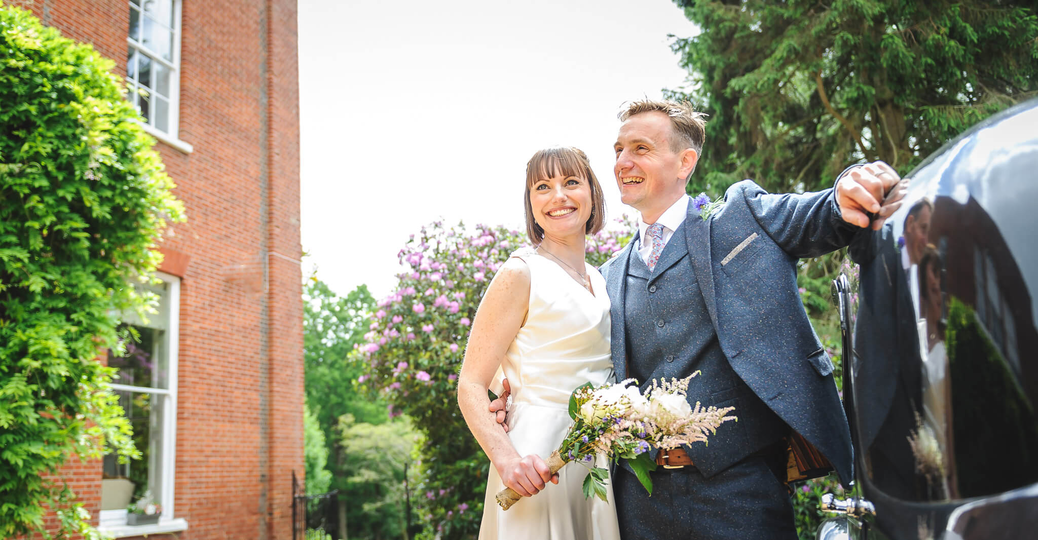Bride and groom by car outside Rownhams House Wedding Photographers