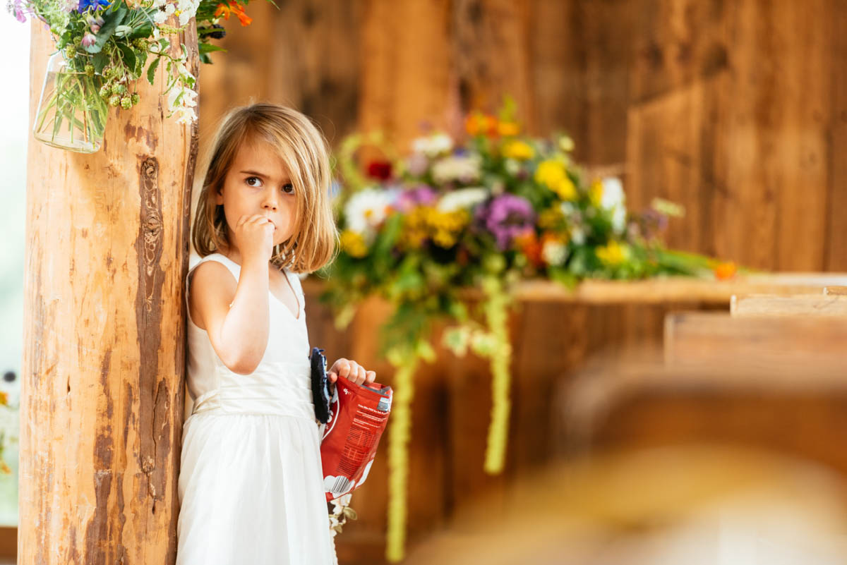 Bridesmaid eating crisps and taking in the atmosphere