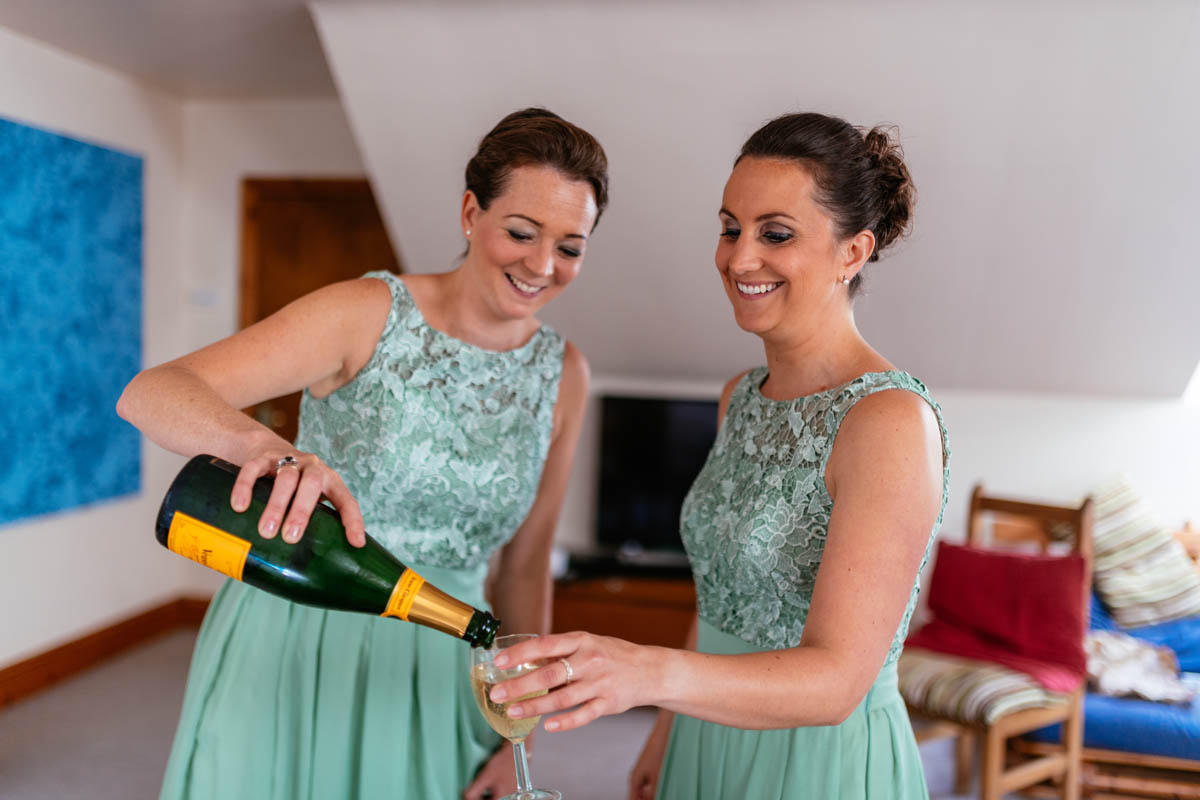 Bridesmaids pouring champagne