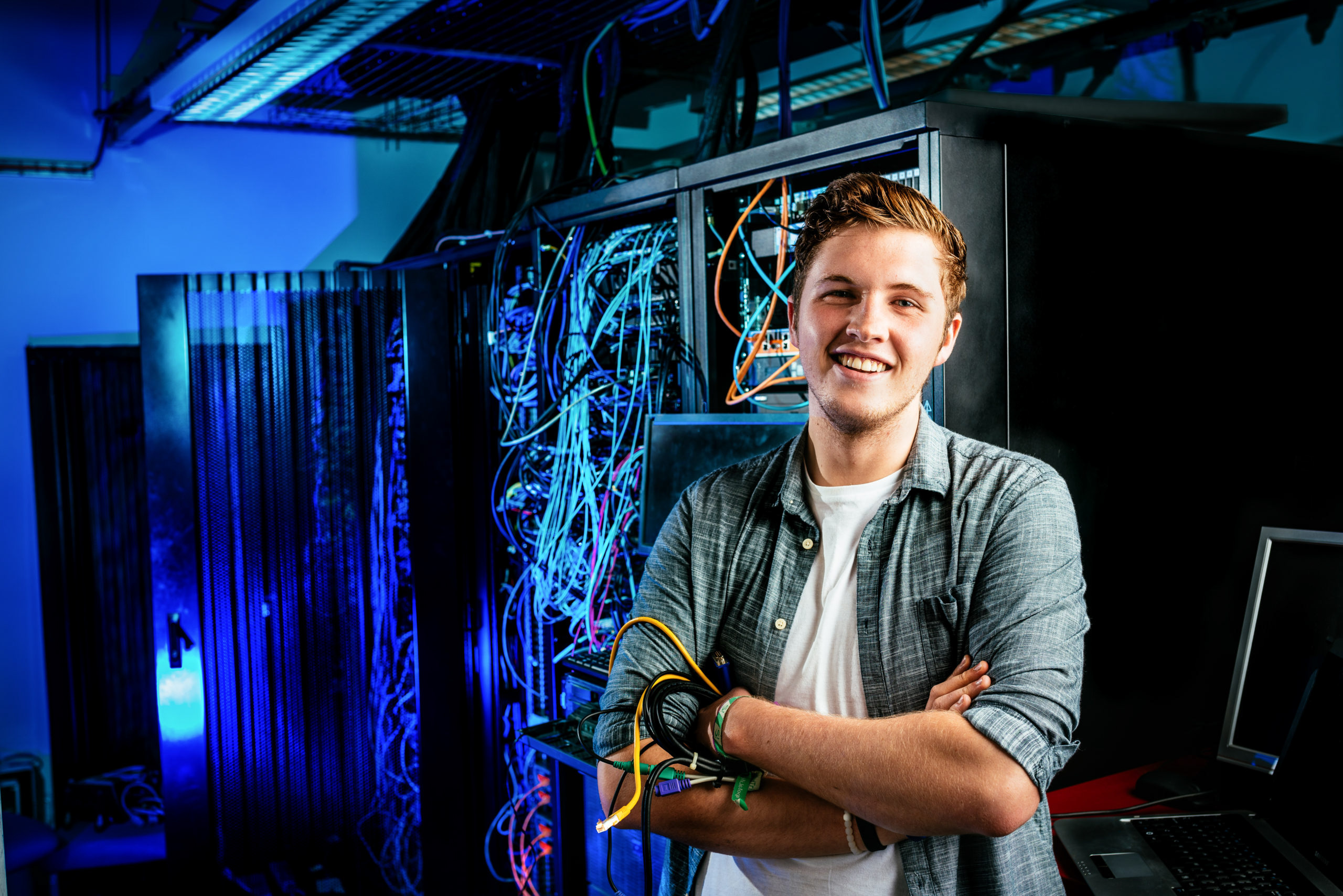 portrait of a man in front of computer servers