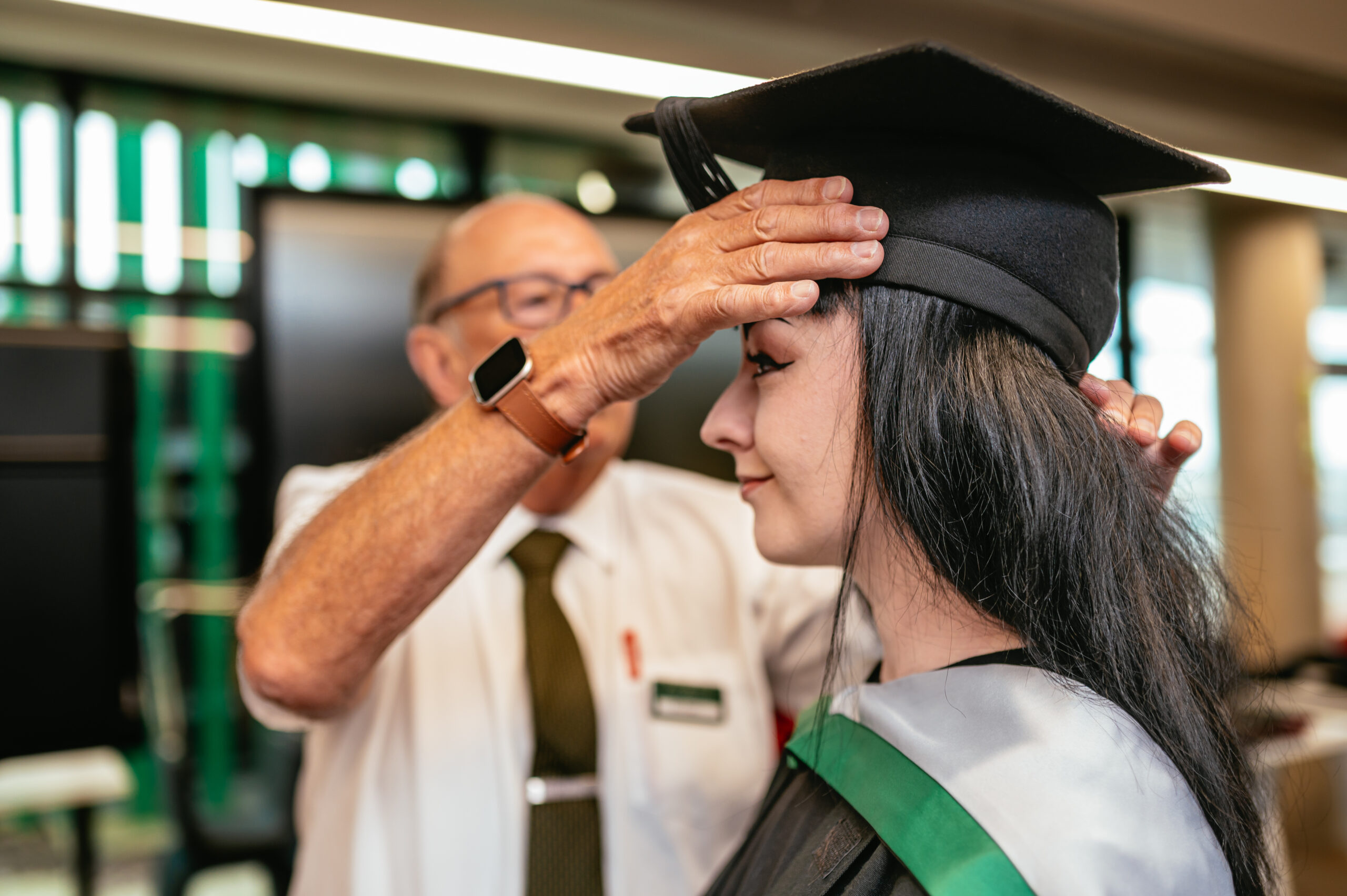 student having cap and gown fitted